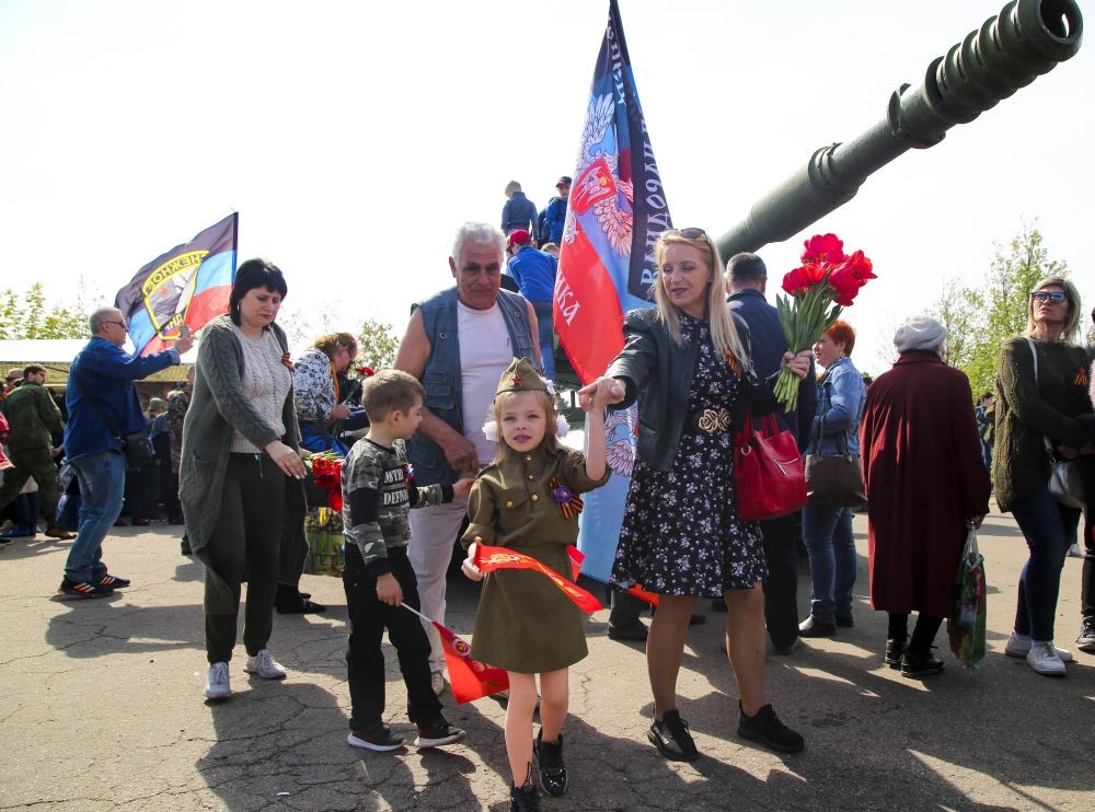 Saur-Mogila: A girl wearing Soviet-era military uniform and her relative walks past a cannon during celebrations of the Victory Day at a World War II memorial in Saur-Mogila, about 60 km (31 miles) east of Donetsk, eastern Ukraine, Saturday, May 8, 2021. Efforts have stalled to end the conflict between Russia-backed rebels and Ukrainian forces, which has killed more than 14,000 people since it broke out in 2014. Russia, which claims it has no military presence in eastern Ukraine, fueled the tensions this year by massing troops and conducting large-scale military exercises near its border with Ukraine. AP/PTI Photo