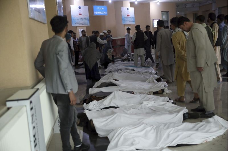 Afghan men try to identify the dead bodies at a hospital after a bomb explosion near a school west of Kabul, Afghanistan on May 8, 2021. A bomb exploded near a school in west Kabul on Saturday, killing several people, many them young students, an Afghan government spokesmen said. (AP/PTI Photo)