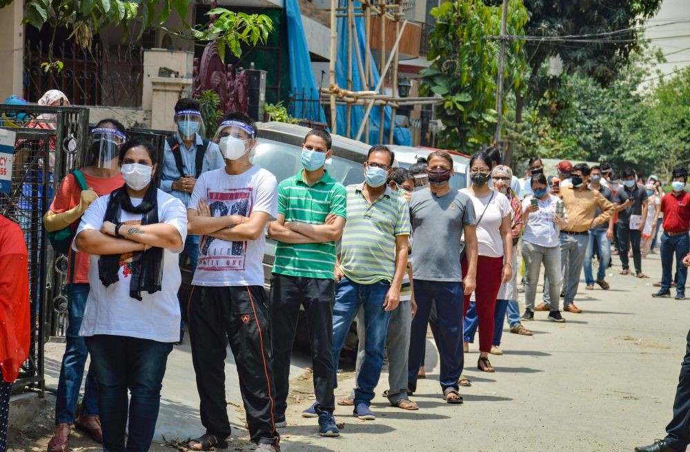 Ghaziabad: Beneficiaries stand in a queue to recieve COVID-19 vaccine dose at a health centre in Vaishali Sector 1, Ghaziabad, Tuesday, May 11, 2021. (PTI Photo)