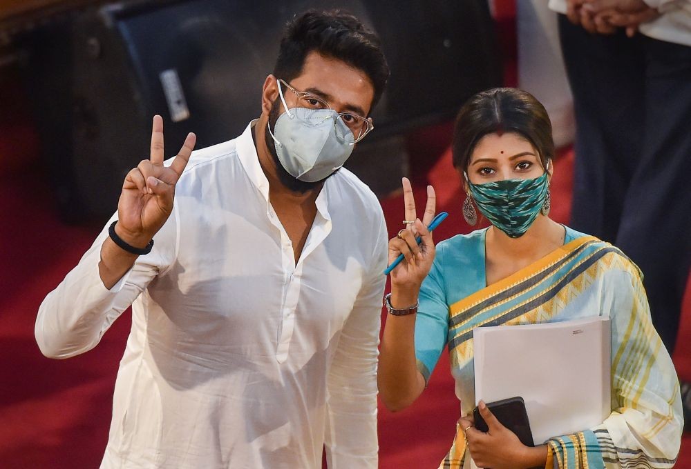 Kolkata: Newly elected TMC MLAs and Bangla film personalities Raj Chakraborty and Lovely Maitra flash victory signs during their oath ceremony inside the West Bengal Legislative Assembly, in Kolkata, Thursday, May 6, 2021. (PTI Photo/Swapan Mahapatra)