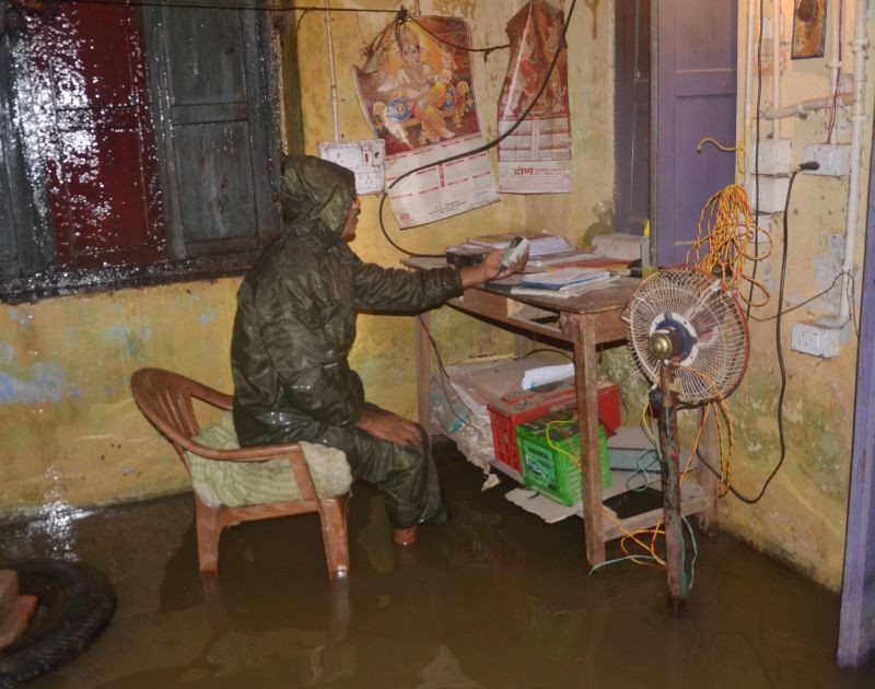 Muzaffarpur: A police personnel sits on a chair inside waterlogged Bela Thana, following heavy rains in the aftermath of Cyclone 'Yaas', in Muzaffarpur, Friday, May 28, 2021. (PTI Photo)