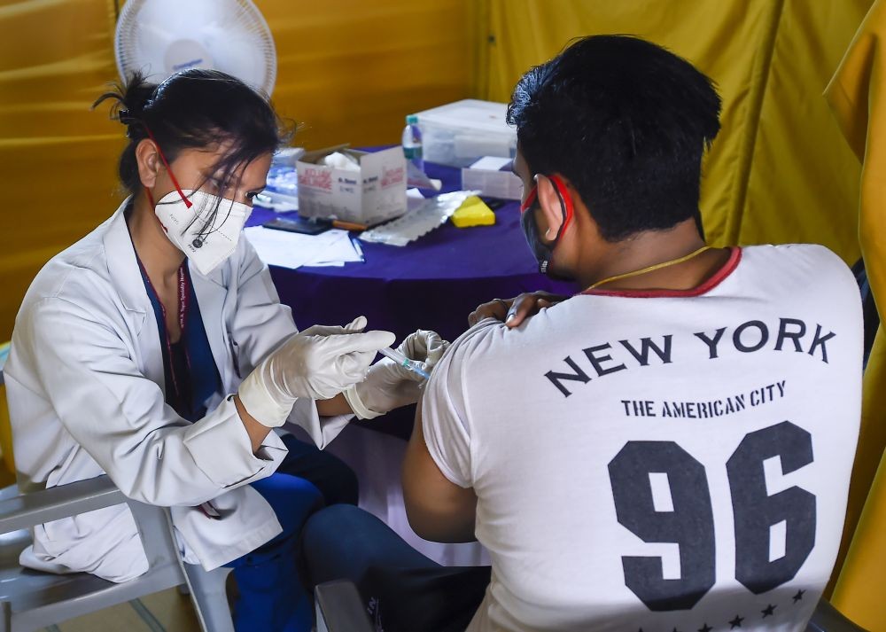 New Delhi: A young beneficiary receives his first dose of COVID-19 vaccine at a vaccination centre set up by BLK-Max Hospital  at the Radha Soami Satsang, in New Delhi, Thursday, May 6, 2021. (PTI Photo/Kamal Singh)