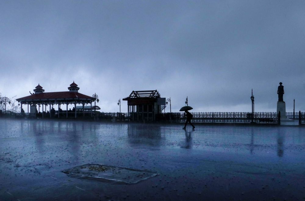 Shimla: A man walks under umbrella amid rains, in Shimla, Thursday, May 13, 2021. (PTI Photo)