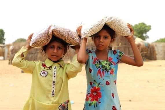 Children receive food from a charity group in Hajjah province, Yemen on March 4, 2021. (IANS File photo)