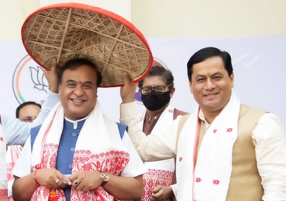 Guwahati : Bharatiya Janata Party (BJP) leader Himanta Biswa Sarma who is set to be the next chief minister of Assam is greeted by outgoing chief minister Sarbananda Sonowal, right in Guwahati, Sunday, May 9, 2021. (PTI Photo)