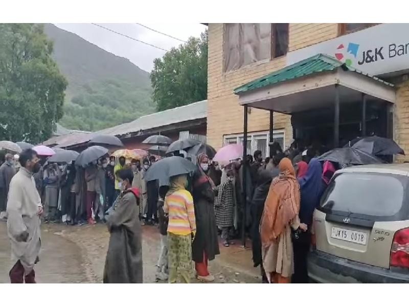 Kashmiris defy logic & lockdown, throng banks, markets. (IANS Photo)