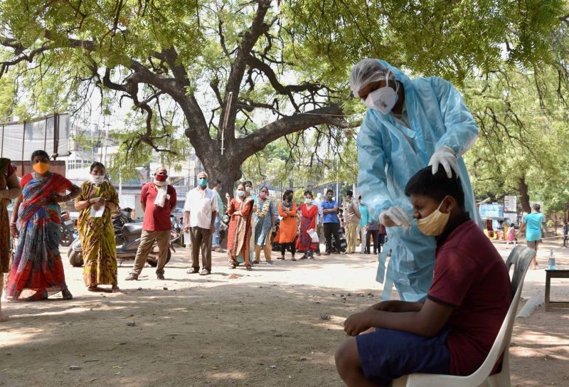 A medical worker takes swab sample of a boy for COVID-19 test at Government Fever Hospital in Hyderabad on May 31, 2021. (PTI Photo)