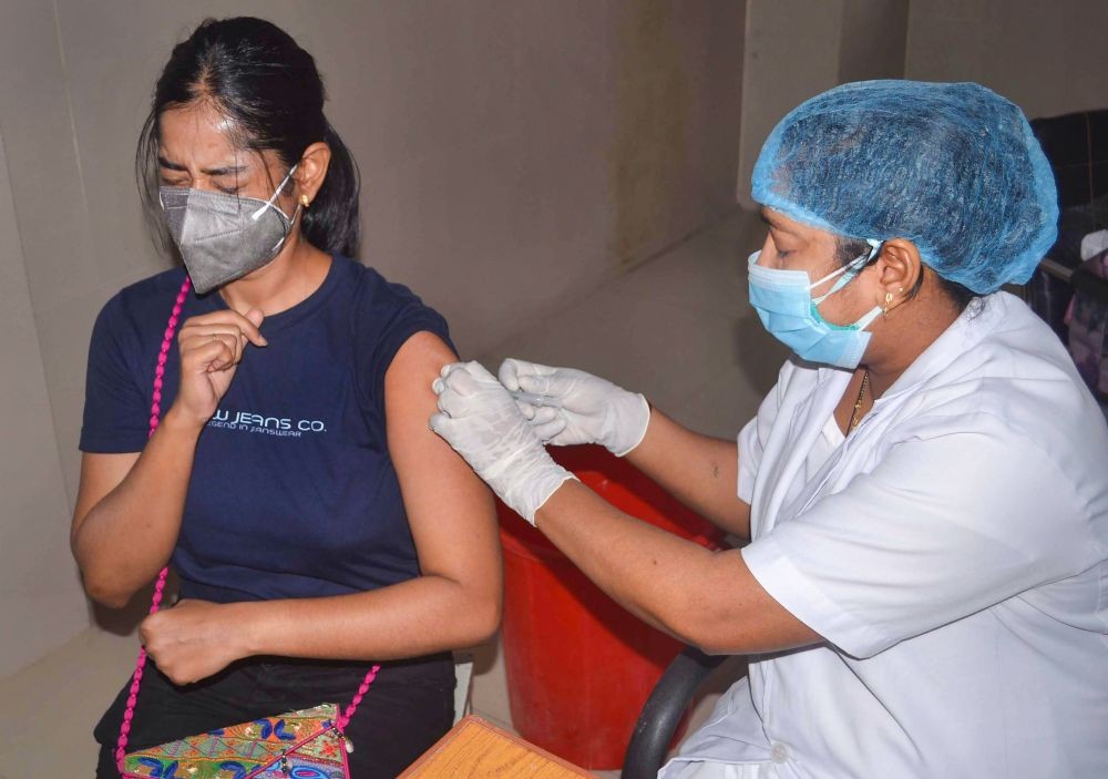 Varaansi : A medic administers a dose of COVID-19 vaccine to a young beneficiary at a vaccination center for Covid-19, in Varaansi, Monday, May 3, 2021. (PTI Photo)