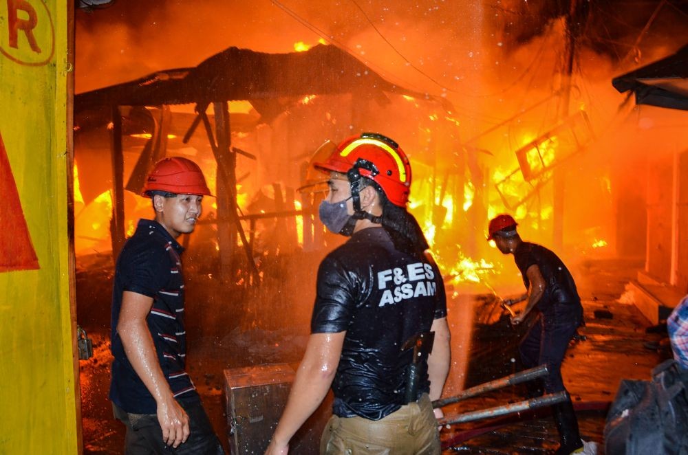 Assam: Fire-fighters try to extinguish a fire in Tezpur Chowk Bazaar, Assam, Sunday, May 9, 2021. (PTI Photo)