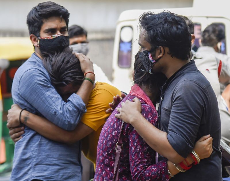 Relatives of a COVID-19 victim react outside the Lok Nayak Jaiprakash Narayan Hospital, during the second wave of coronavirus pandemic, in New Delhi on May 1, 2021. (PTI Photo)