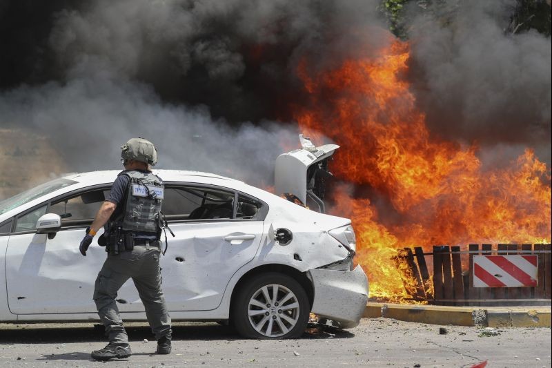 Cars burn after being hit by a missile fired from Gaza Strip, in the southern Israeli town of Ashkelon on May 11, 2021. (AP/PTI Photo)