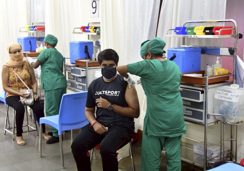 A medic administers a dose of COVID-19 vaccine to citizens during the third phase of  inoculation drive, at Nair Hospital in Mumbai on May 2. (PTI Photo)