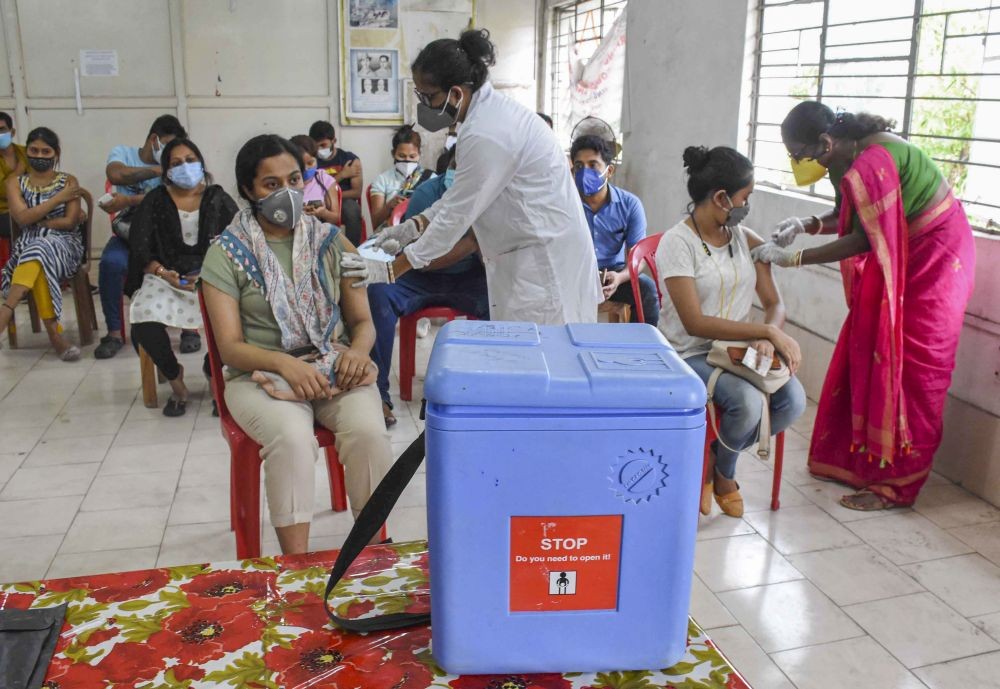 Agartala: A young beneficiary receives COVID-19 vaccine dose at a vaccination centre in Agartala, Thursday, May 13, 2021, (PTI Photo)