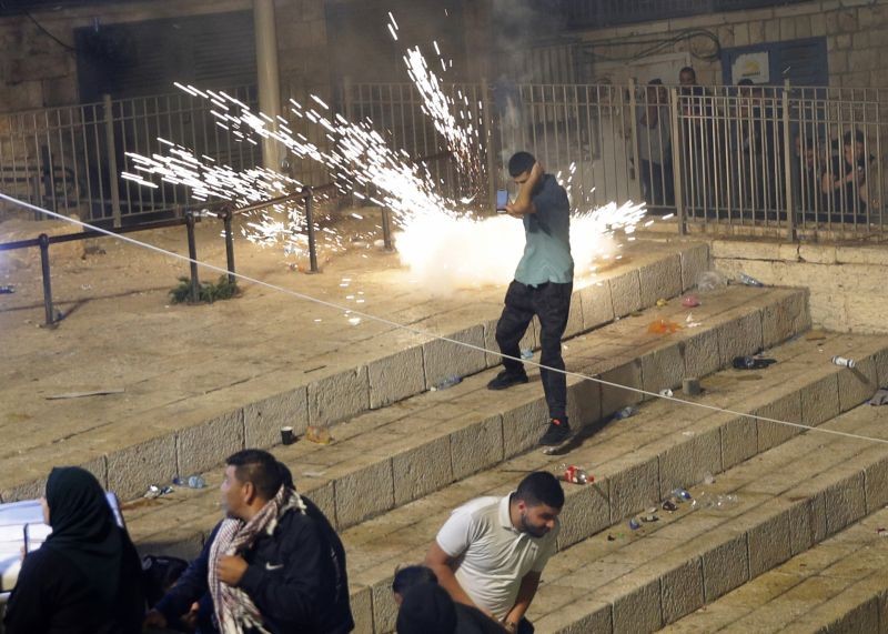 Palestinians run from stun grenades fired by Israeli police officers during clashes at Damascus Gate just outside Jerusalem's Old City on May 8, 2021. (AP/PTI Photo)