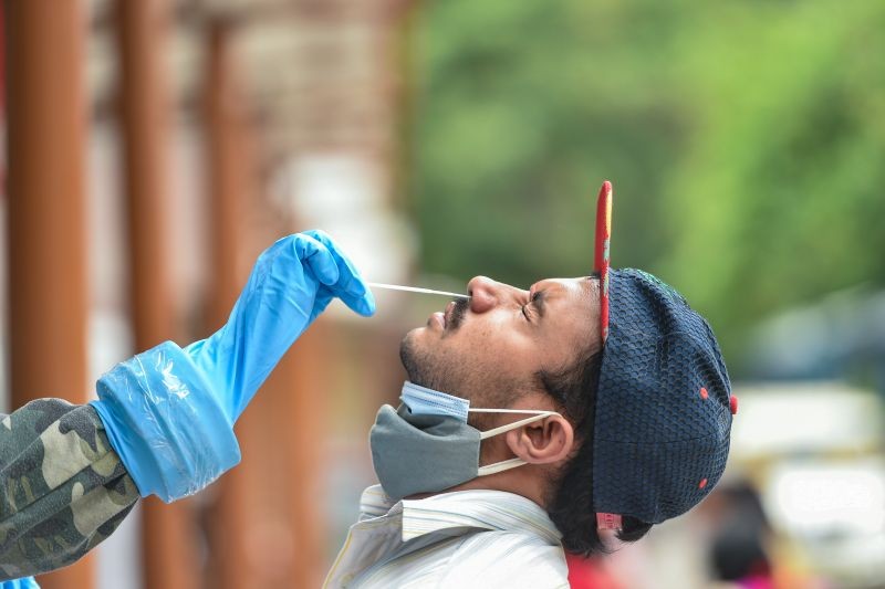 A man gives swab sample for COVID-19 test at RML hospital in Lucknow on May 13, 2021. (PTI Photo)