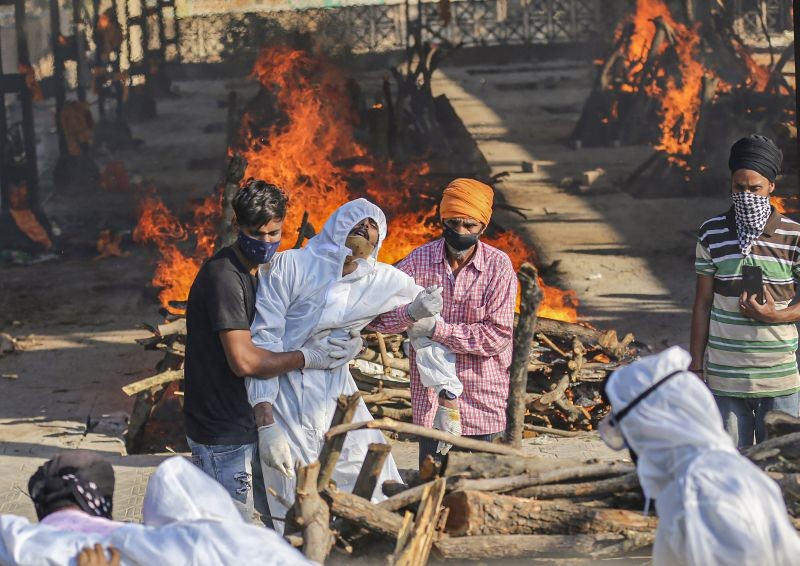 An inconsolable family member while performing the last rites of a COVID-19 victim, in Jammu on May 5, 2021. (PTI Photo)