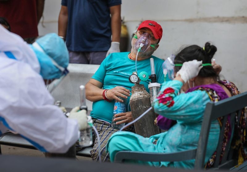 Patients on oxygen support, wait outside the COVID-19 facility of the Chest Disease Hospital in Jammu on May 9, 2021. (PTI Photo)