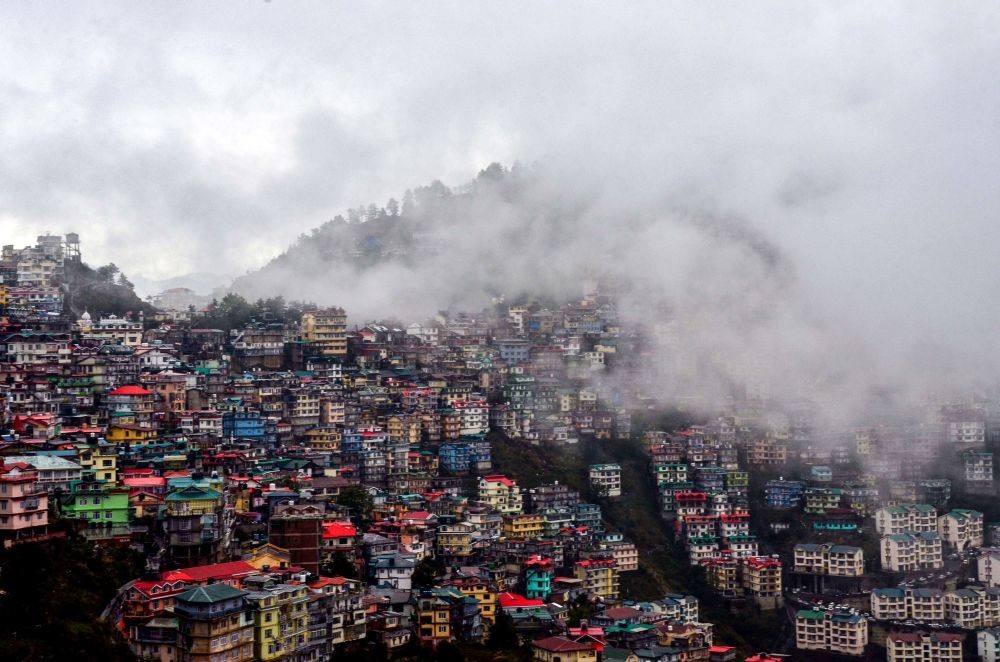 Shimla: View of a city neighbourhood shrouded in mist following heavy rain in Shimla, Thursday, May 13, 2021. (PTI Photo)