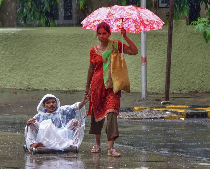 Mumbai: A physically challenged person is taken to safe place amid rains, at Dadar in Mumbai, Friday, June 11, 2021. (PTI Photo)