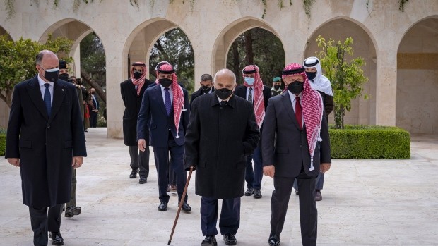 This photo from the Royal Court twitter account, shows Jordan’s King Abdullah II, second right, Prince Hamzah bin Al Hussein, fourth right in blue mask, Prince Hassan bin Talal, fifth right, and others arriving to visit the tombs of former kings, in Amman, Jordan on  April 11, 2021. King Abdullah II and his half brother Prince Hamzah have made their first joint public appearance since a palace feud last week. Members of the Jordanian royal family Sunday marked the centenary of the establishment of the Emirate of Transjordan, a British protectorate that preceded the kingdom. (Royal Court Twitter Account via AP Photo)