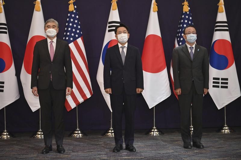 From left, U.S. special representative for North Korea Sung Kim, South Korea's Special Representative for Korean Peninsula Peace and Security Affairs Noh Kyu-duk and Japanese Foreign Ministry's Director-General of the Asian and Oceanian Affairs Bureau Takehiro Funakoshi pose for a photo during their trilateral meeting at a hotel in Seoul Monday, June 21, 2021. (Jung Yeon-je/Pool Photo via AP)