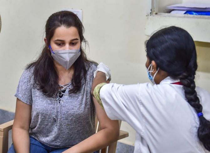 A medic administers COVID-19 vaccine dose to a student during a special vaccination drive organised by the Karnataka government for the students, who are going abroad for education and employment, in Bengaluru, on Wednesday. Photograph: Shailendra Bhojak/PTI Photo