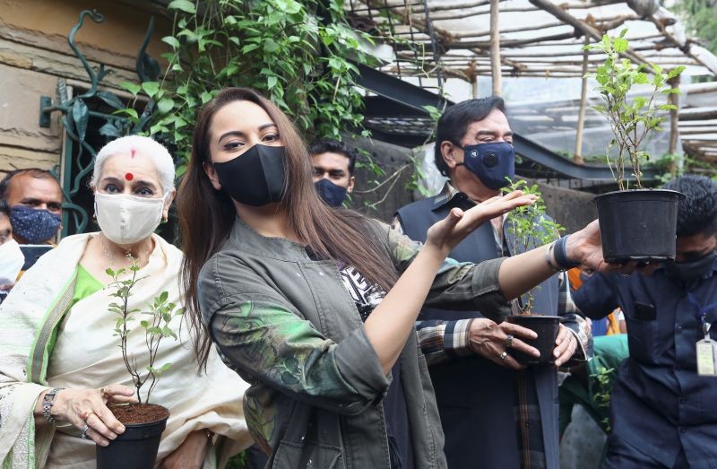 Mumbai: Bollywood actress Sonakshi Sinha poses with a plant during an environment awareness campaign of Make Earth Green Again Foundation, in Mumbai, Tuesday, June 15, 2021. Her parents, Shatrughan Sinha and Poonam Sinha are also seen. (PTI Photo)