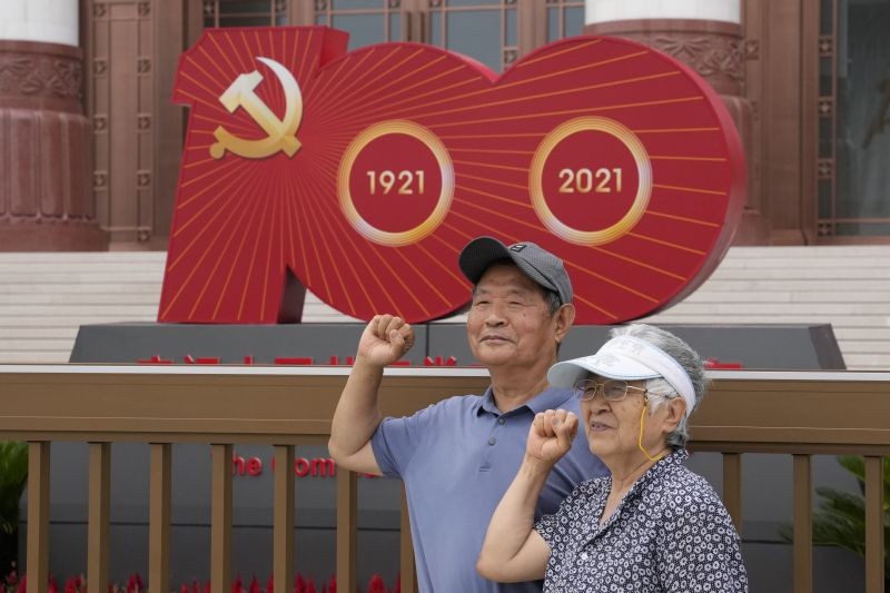 Elderly Communist Party members pose as if swearing in at the logo for the upcoming 100th anniversary of the founding of China's ruling Communist Party outside the Museum of the Communist Party of China in Beijing on June 23, 2021. Chinese authorities have closed Beijing's central Tiananmen Square to the public, eight days ahead of a major celebration being planned to mark the 100th anniversary of the founding of the ruling Communist Party. (AP/PTI Photo)