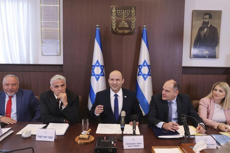 Israeli Prime Minister Naftali Bennett, center, chairs the first weekly cabinet meeting of the new government in Jerusalem on June 20, 2021. Bennett opened his first Cabinet meeting on Sunday since swearing in his new coalition government last with a condemnation of the newly elected Iranian president, whom he called "the hangman of Tehran." (AP/PTI Photo)