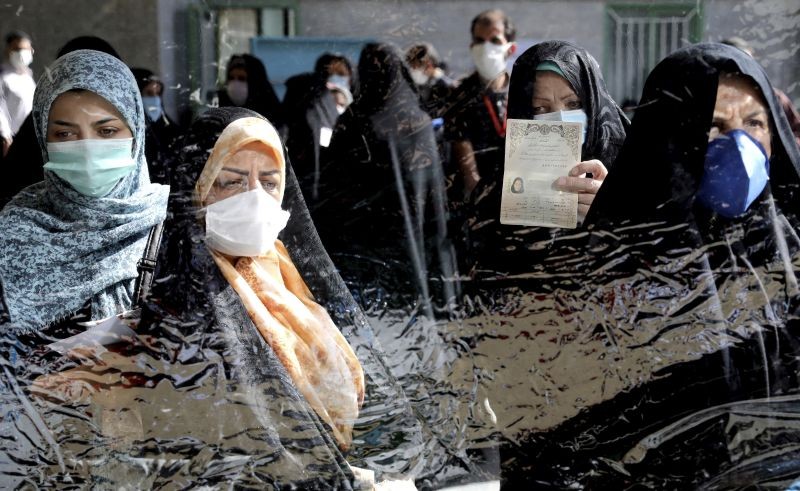 Voters register to cast their vote during the presidential elections at a polling station in Tehran, Iran on June 18, 2021. Iran began voting Friday in a presidential election tipped in the favor of a hard-line protege of Supreme Leader Ayatollah Ali Khamenei, fueling public apathy and sparking calls for a boycott in the Islamic Republic. (AP/PTI Photo)