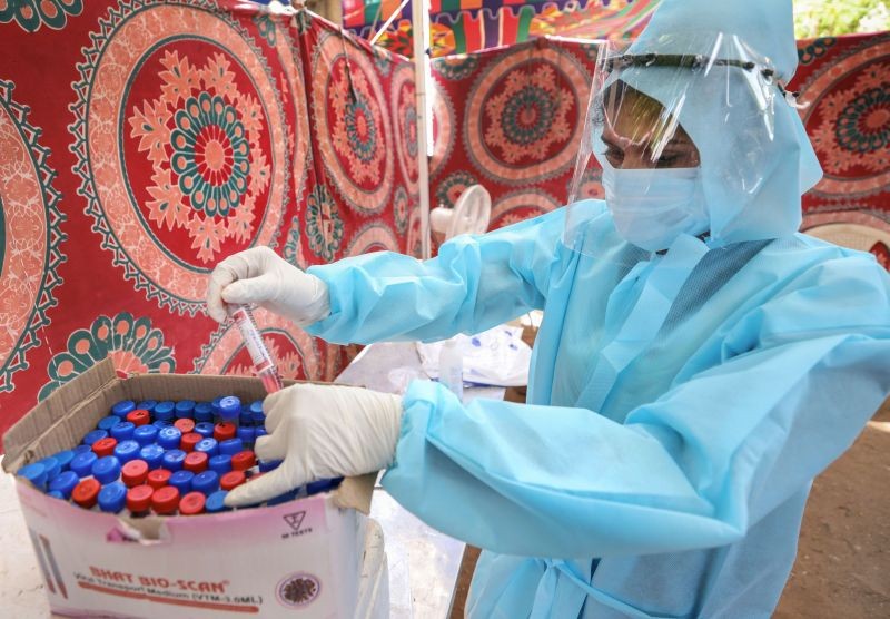 A medic checks the collected swab samples from people, at a government hospital, in Coimbatore on June 9. (PTI Photo)