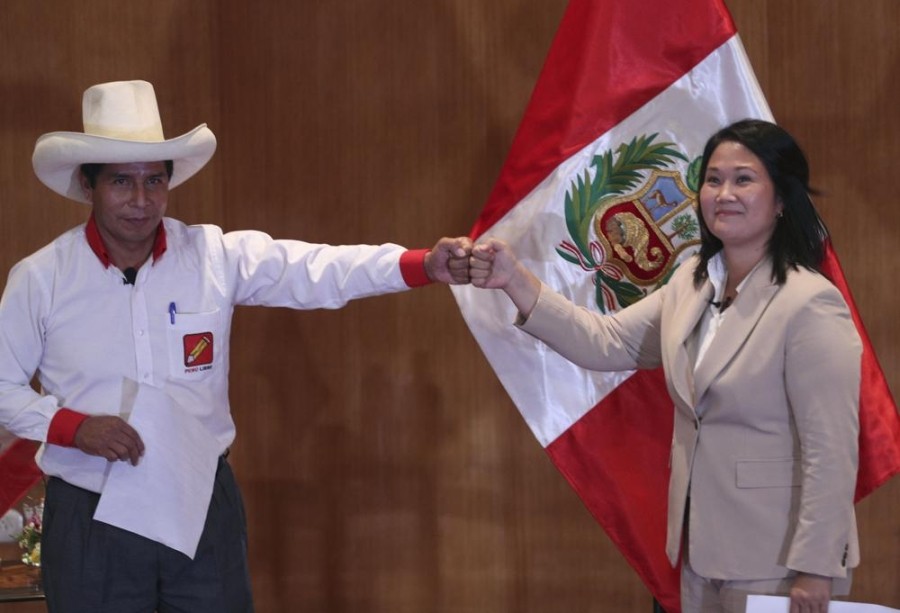 Free Peru party presidential candidate Pedro Castillo bumps fists with rival candidate Keiko Fujimori, of the Popular Force party, at the Peru Medical School in Lima, Peru, Monday, May 17, 2021. The candidates took an oath coined the “Citizens Proclamation” that commits the winner of the June presidential election to defend democracy, to fight COVID-19, to defend the right to life, to guarantee human rights and freedom of the press, as well as to leave the presidency after five years and not seek reelection. (AP Photo)
