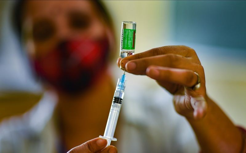 A health worker prepares a dose of the COVID-19 vaccine before inoculating a beneficiary, during a mega vaccination campaign 'Mission June', in Indirapuram on June 1. (PTI Photo)