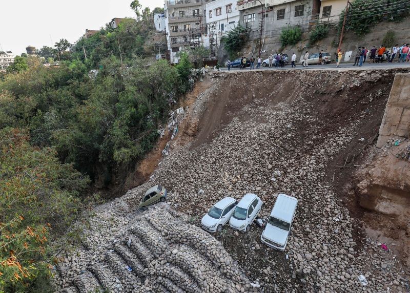 Jammu: Parked vehicles lying damaged after a portion of Jammu circular road connecting Gujjar Nagar with Panjtirthi caved in, Wednesday, June 9, 2021. (PTI Photo)