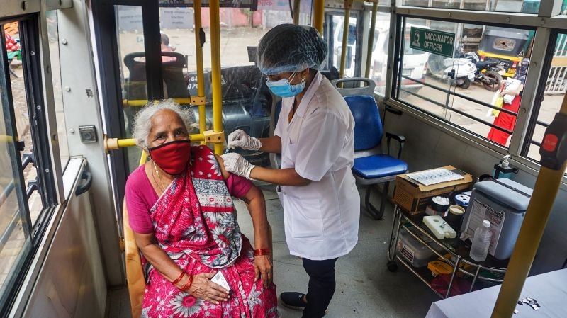 A health worker administers a dose of the COVID-19 vaccine to a beneficiary, in a Mobile Vaccination Van (Center) started by the municipal corporation for disabled and people above 60 years of age, at Indira Nager in Thane on June 7. (PTI Photo)