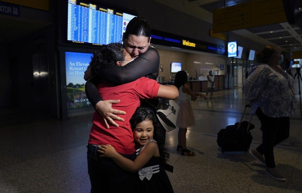 Emely is embraced by her mother, Glenda Valdez in their home after they were reunited, Sunday, June 6, 2021, in Austin, Texas. (AP Photo/Eric Gay)