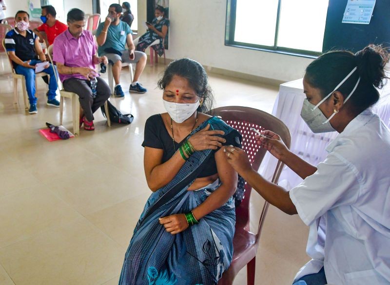 A health worker administers a dose of COVID-19 vaccine, at a vaccination centre at Priyadarshani Park, in Mumbai on June 21, 2021. (PTI Photo)