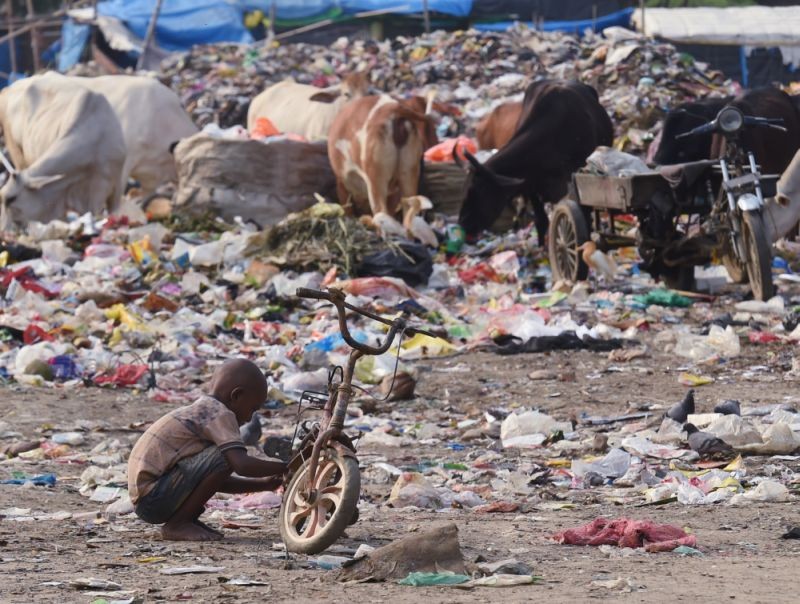 Ghaziabad: A child fixes his bicycle at a garbage dumping site, on the eve of World Environment Day, at Indirapuram in Ghaziabad, Friday, June 4, 2021. (PTI Photo/Atul Yadav)