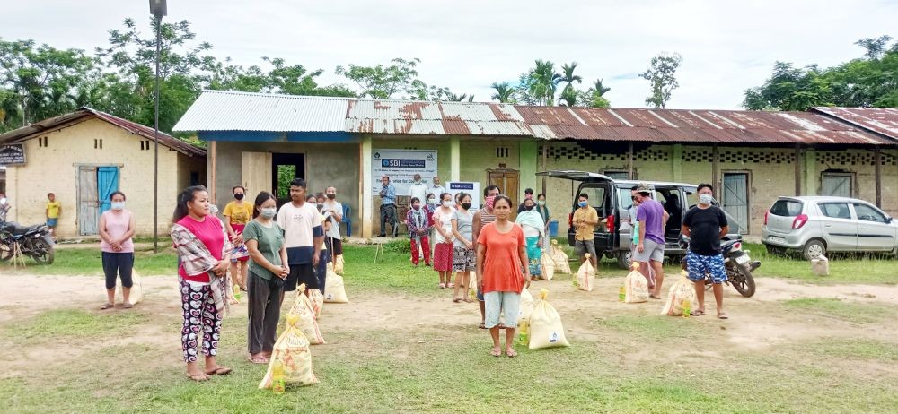 Beneficiaries receiving dry rations during the distribution programme in Diezephe village.