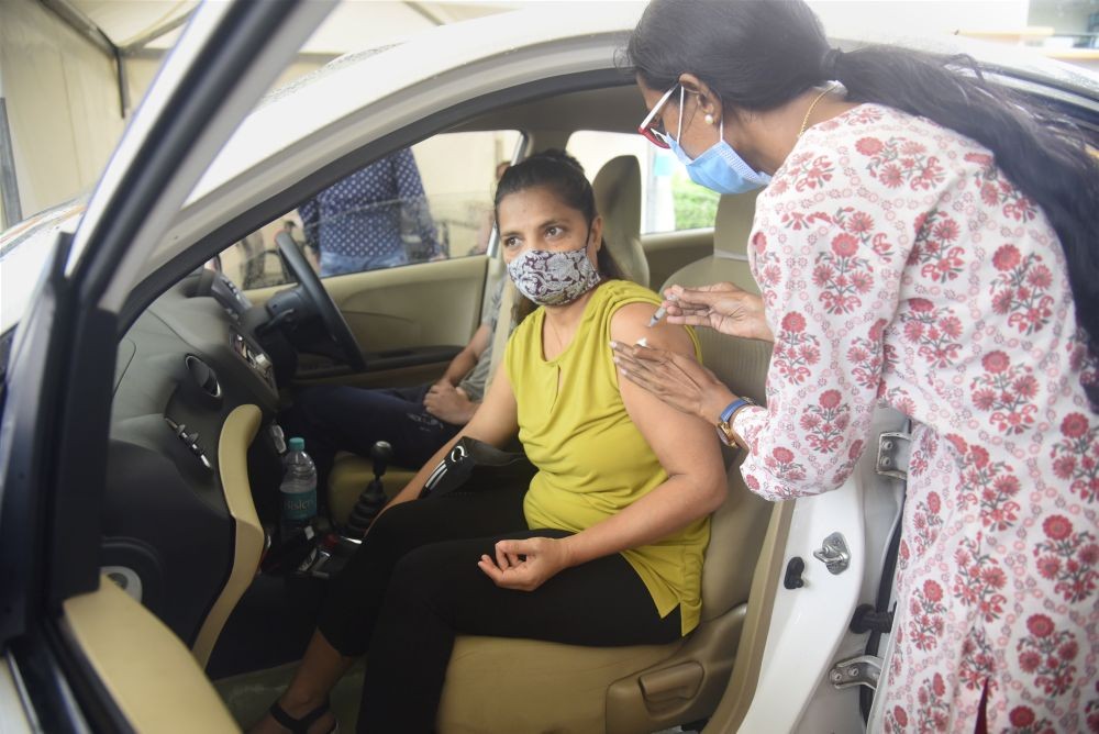 Mumbai: A health worker administers a dose of COVID-19 vaccine to a beneficiary during a drive-in vaccination camp by BMC, at Kandivali in Mumbai, Friday, June 25, 2021. (PTI Photo)