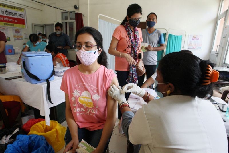 Prayagraj: A health worker administers a dose of a COVID-19 vaccine to a woman, at a Railway hospital in Prayagraj, Friday, June 11, 2021. (PTI Photo)