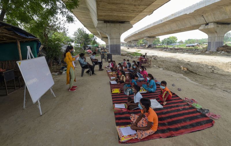 New Delhi: Students from a slum area attend an open-air tuition class at Panchsheel Shikshan Sansthan, in New Delhi, Thursday, June 10, 2021. (PTI Photo/Manvender Vashist)