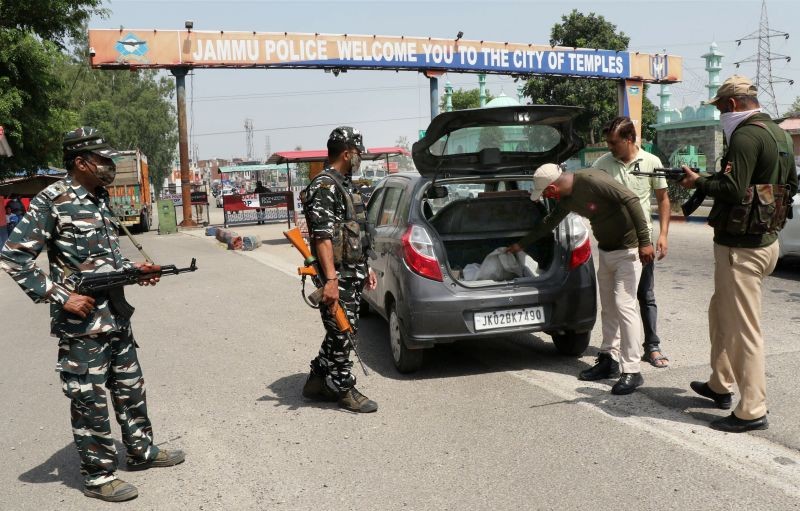 Security personnel check a vehicle at Jammu-Pathankot National Highway on June 29, after troops spotted drones separately flying over Kunjwani and Kaluchak at midnight. (PTI Photo)