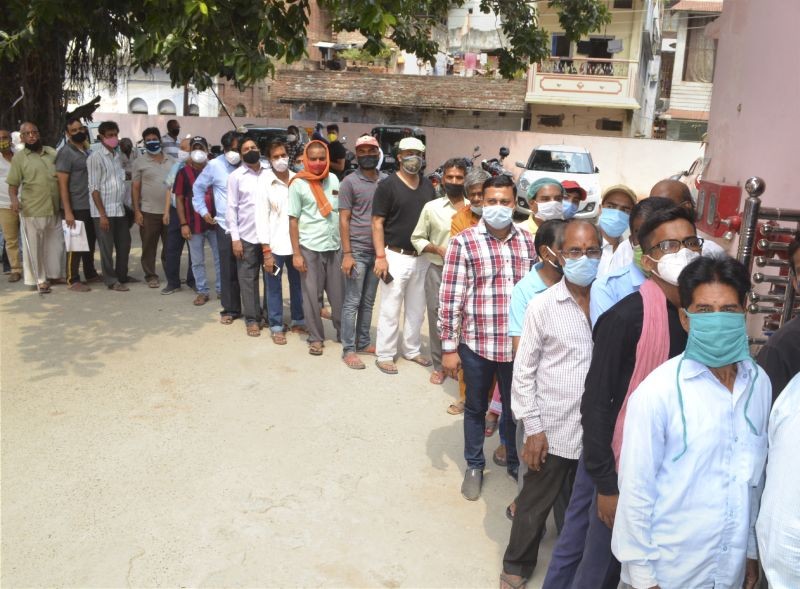 Beneficiaries wait in a long queue to receive Covid-19 vaccine dose, at a vaccination center in Varanasi on June 8. (PTI Photo)