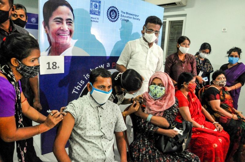 Beneficiaries receive COVID-19 vaccine dose during 'Free Mega Vaccination Camp' in presence of West Bengal Transport and Housing Minister Firhad Hakim, in Kolkata on June 16, 2021. (PTI Photo)