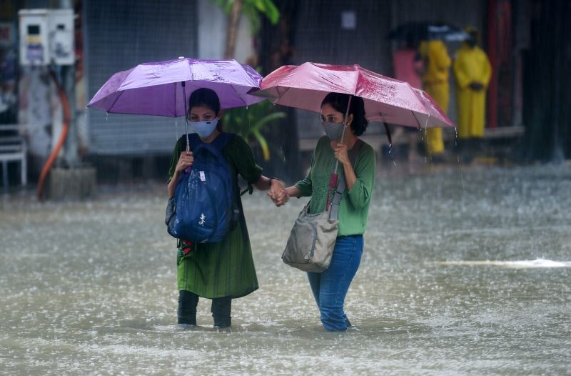 Mumbai: People wade through a waterlogged street at Hindmata in Mumbai, Wednesday, June 9, 2021. (PTI Photo/Shashank Parade)