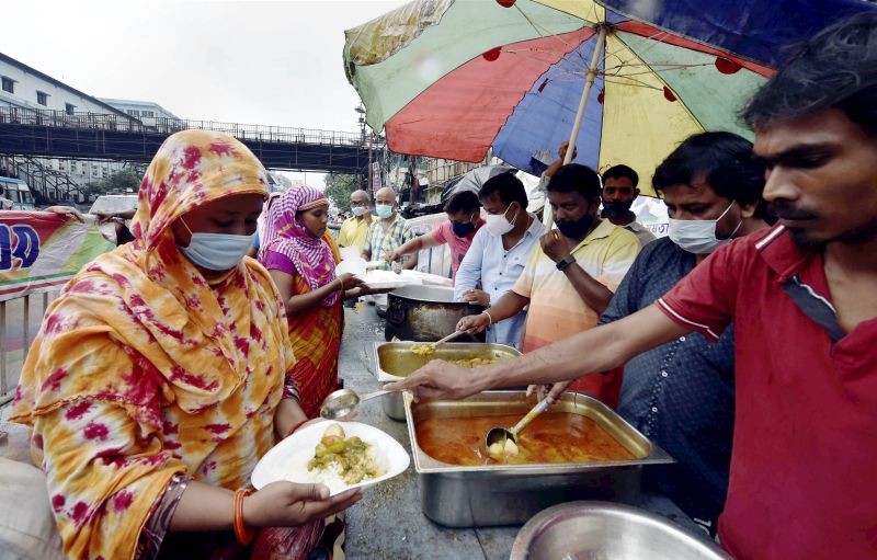 TMC workers distribute free food to needy people during the ongoing COVID-induced lockdown, in Kolkata on June 15, 2021. (PTI Photo)