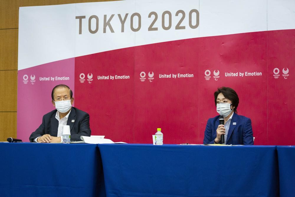 Tokyo 2020 CEO Toshiro Muto, left, and President Seiko Hashimoto attend the news conference after receiving a report from a group of infectious disease experts on Friday, June 18, 2021, in Tokyo. The experts including Shigeru Omi, head of a government coronavirus advisory panel, issued a report listing the risks of allowing the spectators and the measurements to prevent the event from triggering a coronavirus spread. (Yuichi Yamazaki/Pool Photo via AP)