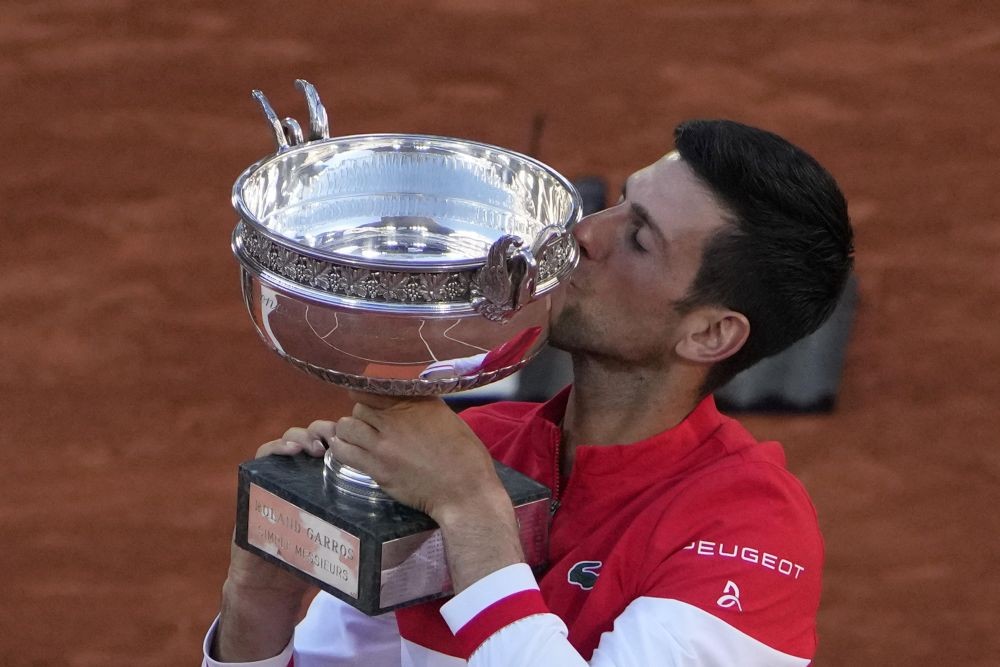 Paris : Serbia's Novak Djokovic kisses the cup after defeating Stefanos Tsitsipas of Greece during their final match of the French Open tennis tournament at the Roland Garros stadium Sunday, June 13, 2021 in Paris. Djokovic won 6-7, 2-6, 6-3, 6-2, 6-4. AP/PTI