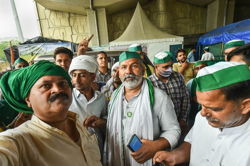 Supporters  takes a selfie with BKU spokesperson Rakesh Tikait  during farmers' protest against three farm reform laws at Ghazipur border in New Delhi on June 27, 2021. (PTI Photo)